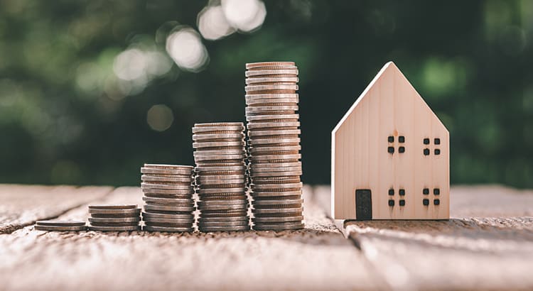 Investment in the real estate business. Money coin stack growing graph and wood house model. Loans for the purchase of residential houses. Save for the future.