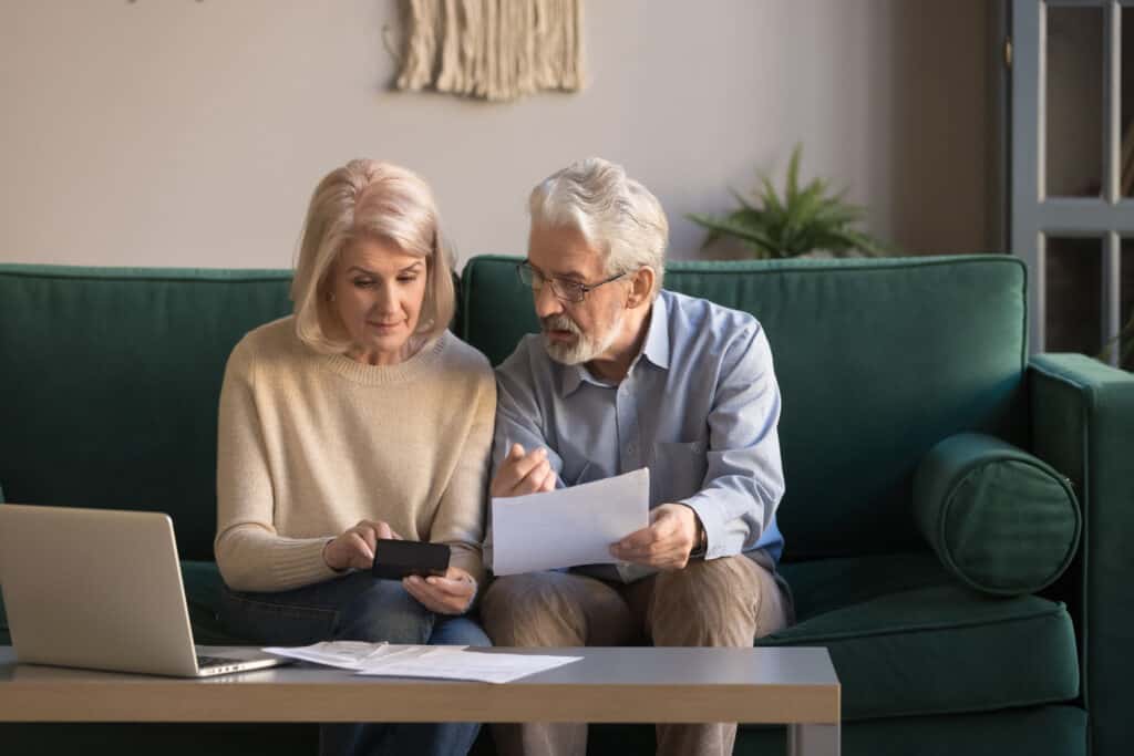 Couple calculating savings from downsizing