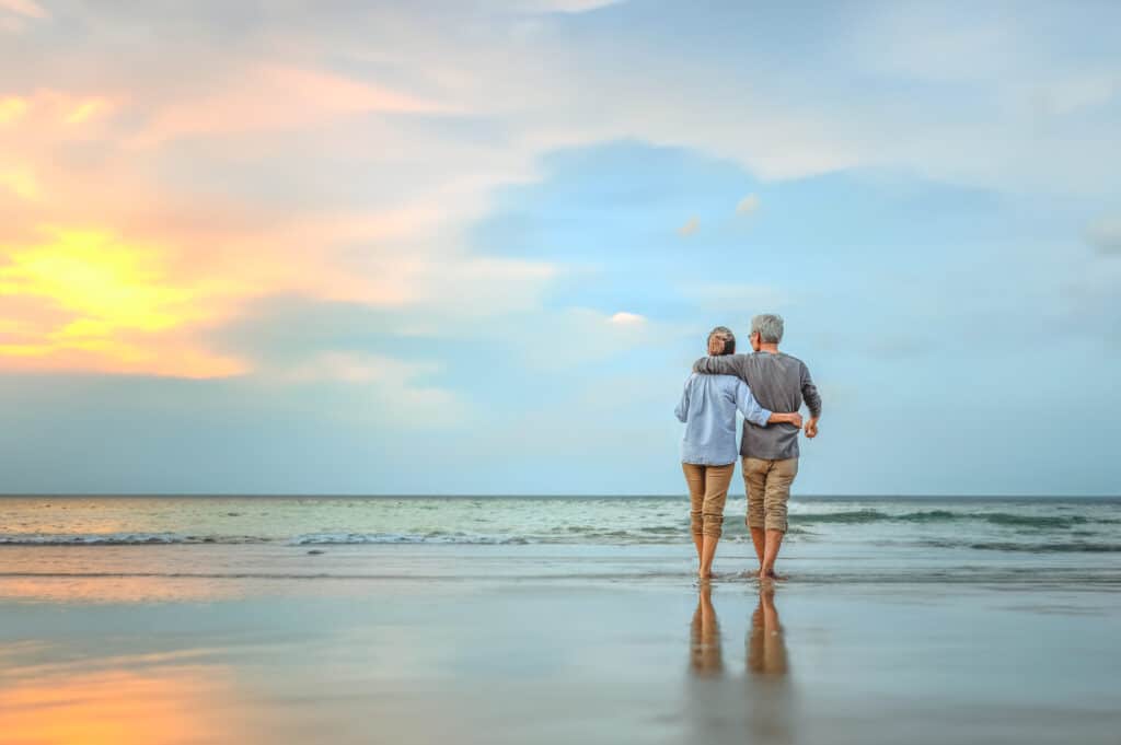 Couple on beach of retirement home